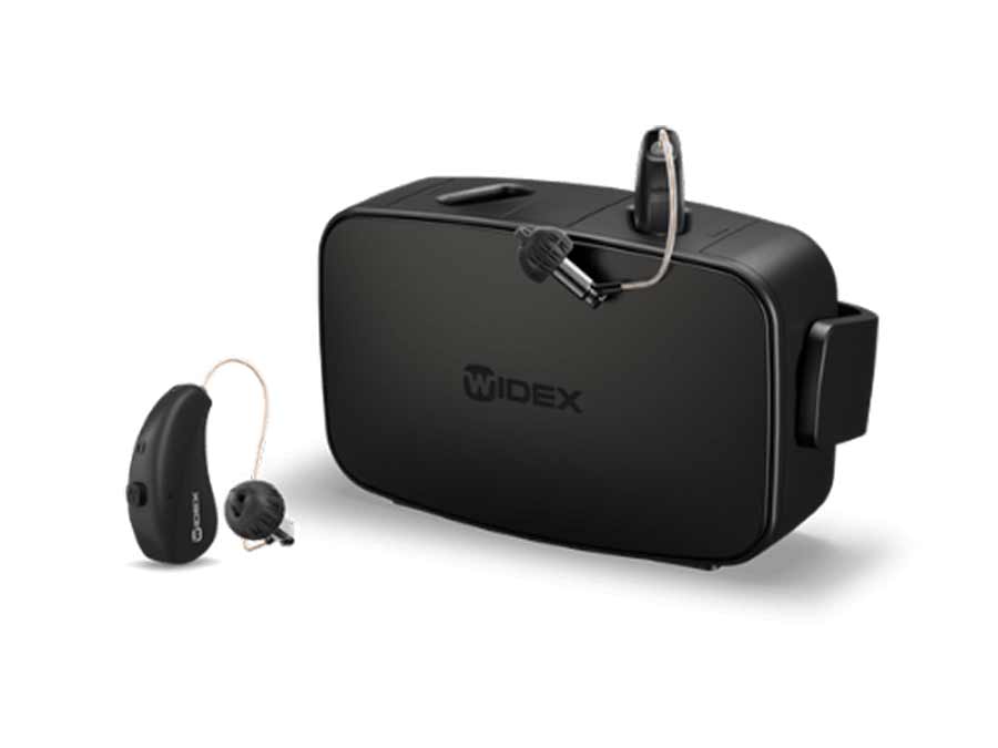 Discreet Widex Moment Hearing Aids in charging station - available at True Tone Hearing in Northern Ireland