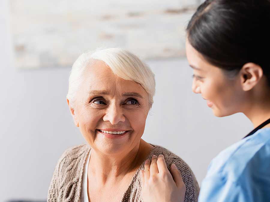 An audiologist at True Tone Hearing Belfast chats to a patient