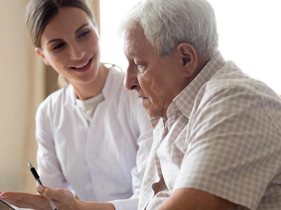 An audiologist at True Tone Hearing in Belfast discusses hearing test results with a patient